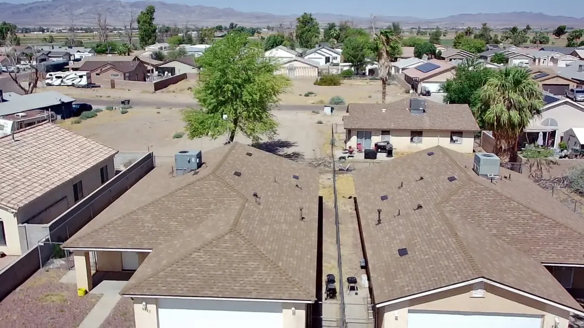 Aerial view of a completed brown shingle roof on a single-story Lake Havasu City home