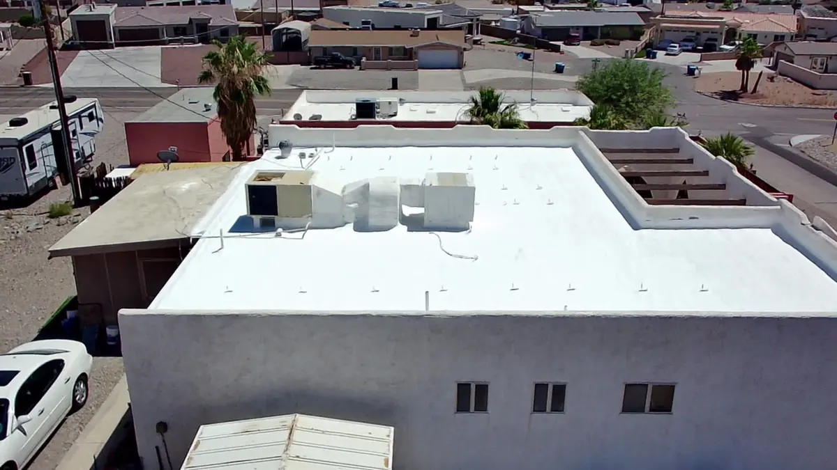 Aerial view of a repaired and freshly coated white flat roof in Lake Havasu City